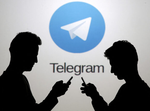image-file-photo-two-men-pose-with-smartphones-in-front-of-a-screen-showing-the-telegram-logo-in-this-picture-illustration-taken-in-zenica