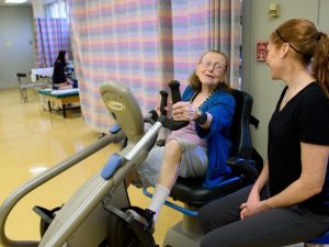 image-woman-on-exercise-bike-with-therapist_0