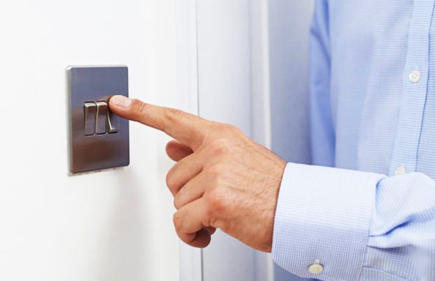 image-close-up-of-man-turning-off-light-switch