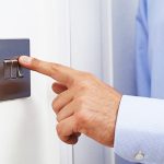 image-close-up-of-man-turning-off-light-switch