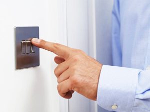 image-close-up-of-man-turning-off-light-switch